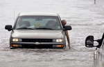 September, 24, 2005 - Jean Lafitte, Lousiana - A motorist examines rising floodwaters as he makes his way out of the area. This community is experiencing the effects of Hurricane Rita which followed Hurricane Katrina. 