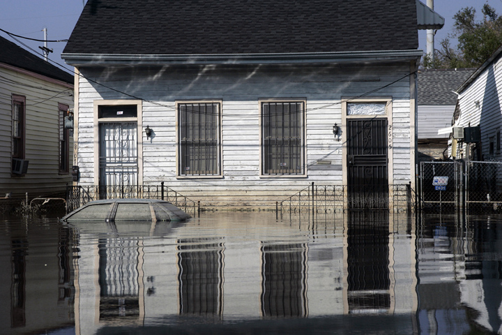 September 9, 2005 - New Orleans, Louisiana -  Receding floodwater leaves its mark on a house and automobile on Orleans Avenue. 