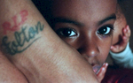 Macquala McCormick, 5, is enveloped by her mother whose tattoo memorializes Macquala’s father who was shot to death. This photo was part of a project that highlighted six children whose fathers were violently killed; they are the unseen victims seldom isolated from the violence that claimed their fathers. No matter how well or little they knew him - whether as a myth, a memory or a beloved pal mourned - a father's absence leaves a void.
