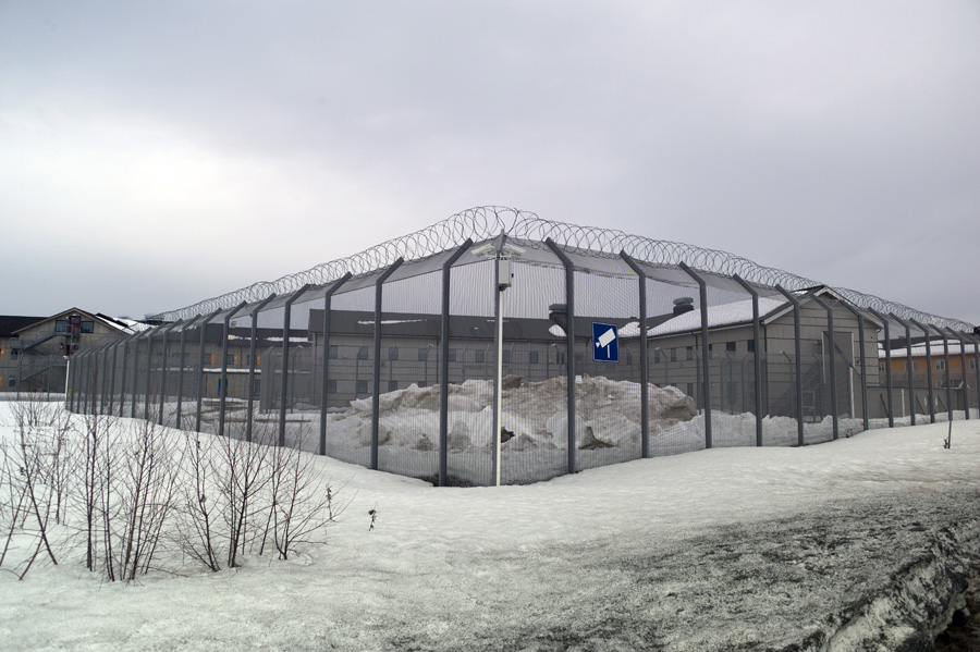 A security fence with barbed-wire outlines Trandum Detention Centre.