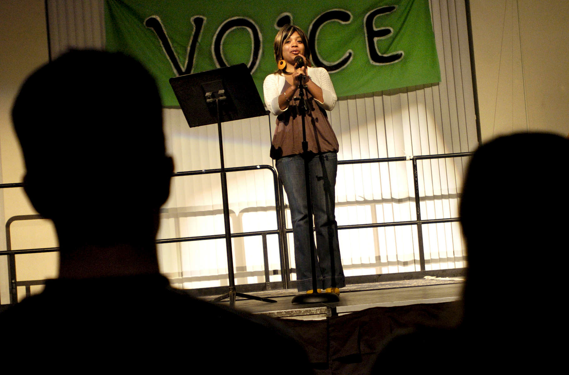 (03/16/09)(Photo by Jason McKibben) --  Atlanta poet Dana Gilmore, who was twice featured on HBO's Def Poetry Jam, performs some of her work at {quote}Voice,{quote} a women's history month poetry event about the female voice and the empowerment of women hosted by Colby College Monday night, March 16, 2009. Additional spoken word poetry was performed by Colby students and faculty. 