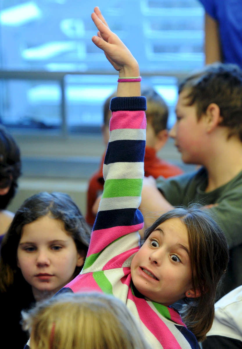 Jason McKibben - jmckibben@poststar.comEmily Clark, a 4th-grader at Greenfield Elementary School, emphatically raises her hand to answer a question posed by guest scientist Steve \{quote}The Dirtmeister\{quote} Tomecek during a workshop in the school\'s library Friday, December 16, 2011. Tomecek was visiting the school Thursday and Friday to offer fun and interactive ways to approach science and writing.