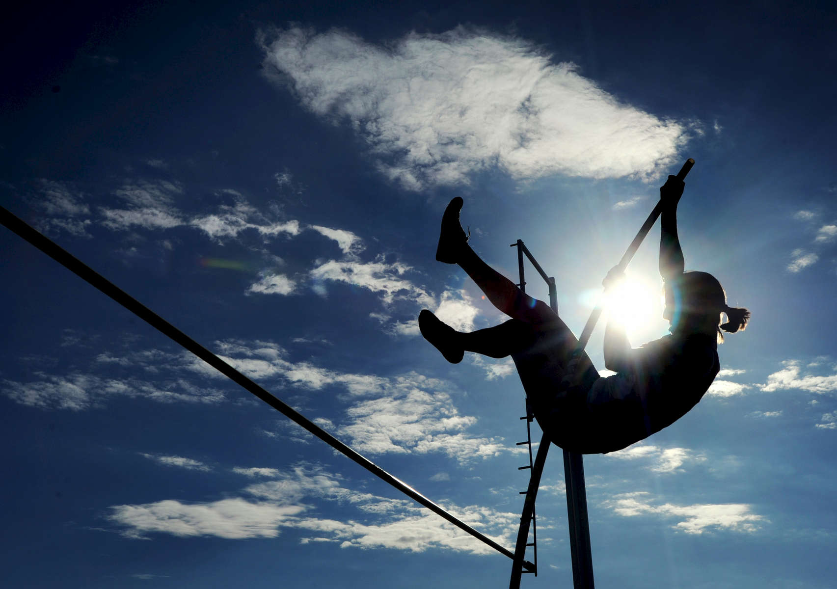 Cassandra LaFave of Glens Falls goes up and over the 6-foot mark as she competes in the pole vault event during a Foothills Council track and field meet against Hudson Falls Tuesday, April 3, 2012. (Jason McKibben - jmckibben@poststar.com)