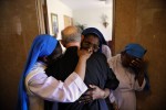  The nuns,  Sr.Mary Henrietta Iroghumg, Sr. Mary Victur Egbokg, Sr. Mary Victoria Loeka and Sr. Mary Obi Oraka say their goodbyes and embrace Msgr. Granato near the front door of the Rectory as he exits Tueday after Mass.  The Last mass celebrated by Msgr. Granato at St. Lucy's Church, Newark is held Tuesday morning. The monsignor, who is 80 and spent 54 years at the church, he must move out upon the orders of the diocese of Newark.   Photographed for The Star-Ledger