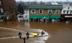 A Bound Brook Police Officer  rides down Main St. in Bound Brook, NJ looking for residents to be evacuated.  Residents evacuate and are rescued by Bound Brook Police and Rescue Squad and Somerset County Dive Team in  Bound Brook as the Raritan River rises from heavy rains. Photographed for The Star-Ledger