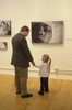  Star-Ledger photographer Matt Rainey and his daughter Brenna look at the photographs during the opening reception for {quote}After The Fire{quote} in the Paul Robeson Gallery at Rutgers University in Newark on 11/27/2001. The show runs Nov 26-Jan 6.  SCOTT LITUCHY / THE STAR-LEDGER