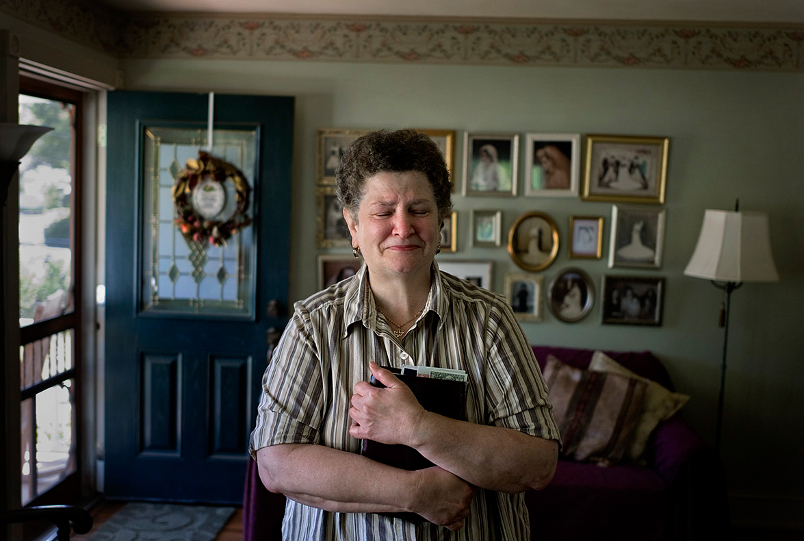 Rose, an uninsured NJ resident clutches her Bible at home. Photographed for Catholic Health East