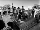The villagers of Ahuehuetitla, Mexico move through town enroute to the cemetery on the edge of the village to bury 14 year-old Juan Manuel Calixto with his paternal grandmother. The teen was shot and killed in Passaic, NJ defending a fellow gang member. His family flew him home for burial.  Photographed for The Star-Ledger