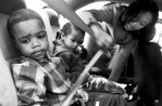 Sharon now has to raise her three children without their father. She buckles her kids into the back seat of the car for a trip to church. Sean, the eldest at age 5 says he misses his father. 