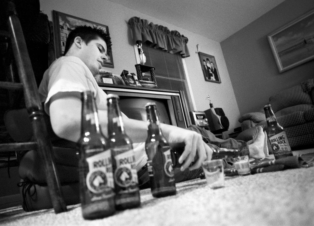 Jason pours himself another beer during a {quote}power hour{quote} of drinking with his friend and sister on a Thursday night.  Jason's drinking, along with his sister's, increased after their father's death. 