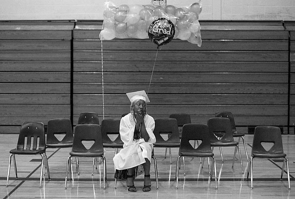 Ayisha sits alone on graduation day.  Later, she says that receiving her diploma made her feel  {quote}clean...you know, like I accomplished this. This is for the rest of my life.{quote}