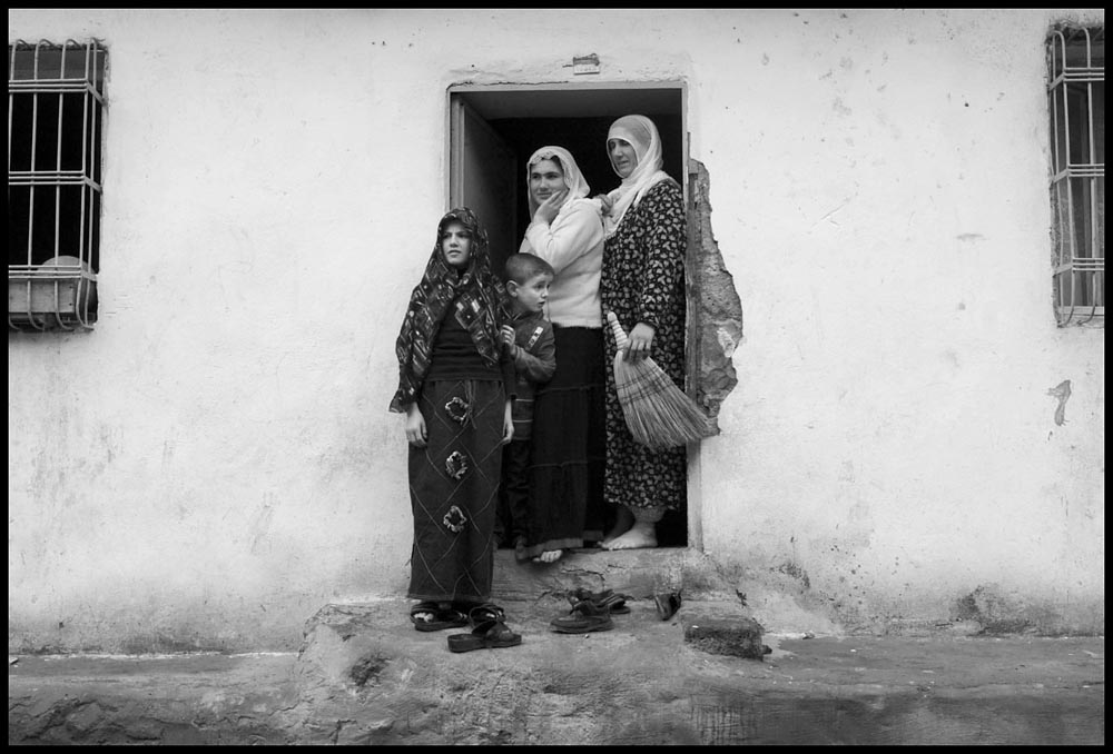 A family stands in the doorway of their home in the southeastern turkish city of Diyarbakir on a December morning.  The city, said to be the oldest in the world is unofficially known as the proxy capital of the Kurdish people. Turkey fears a possible attemp for Kurdish independence should the U.S. attack Iraq.