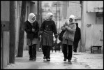 Three young girls walk to school in the Baqaa Palestinian Refugee Camp near Amman, Jordan.  The camp contains approx 150,000 refugees and is the largest of the 19 official refugee camps in the Middle East and the largest of 9 in Jordan.  Jordan has been placed in a difficult position by U.S. foreign policy in the it is geographically located between Israel and Iraq and has to cope with the Israeli/Palestinian issie and the possible U.S. led invasion of Iraq. 