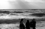 Women and their children enjoy the Mediterranean Sea in Gaza. 