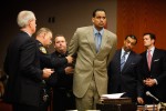 Jayson Williams is handcuffed by Somerset County Sheriffs Officers as he is taken into custody Tuesday, eight years and 10 days after he fatally shot his 55-year-old limousine driver Costas Christofi at his former Hunterdon County estate.Williams, 42 is  sentenced to at least 18 months in prison Tuesday as he appears before Superior Court Judge Edward Coleman.Mr. Williams appears with his attorneys Joseph Hayden and Billy Martin.Williams pleaded guilty Jan. 11 to a downgraded charge of aggravated assault under the terms of a plea agreement reached Dec. 24 with the State Attorney General's Office, which took over the case from the Hunterdon County Prosecutor's Office.Williams, who was awaiting retrial on a reckless manslaughter charge, also waived his right for post-conviction relief, a legal motion to set aside a conviction before filing an appeal. 