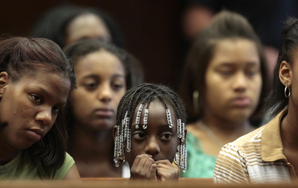 Kala Jenkins (age 9) (center), the daughter of murder victim {quote}Rocky{quote} Jenkins sits in Essex County Court  during the sentencing of her father's killer Edward Peoples. Seated with her are Medina Kenkins (left) a niece and Faja Jenkins (age 13) (left center behind), {quote}Rocky{quote} Jenkins other daugther. Edward Peoples of Newark, NJ is sentenced to 65 years in prison before Essex County Superior Court Judge Michael Ravin . In the court were the victim, {quote}Rocky{quote} Jenkins' family including his parents and his daughters. Edward Peoples tried everything to avoid a murder conviction, including spiriting his girlfriend out of state, going on the lam and convincing a friend to testify he wasn't there. Photographed for The Star-Ledger