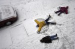 Making snow angels outside their building along Dr. Martin Luther King Blvd. in Newark, NJ  during a snowstorm are Shoataisa Jones (age 9),  Tamika Boynes (age 5) and Shanik Austin (age 6). Photographed for The Star-Ledger