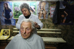 Hair dresser Pavlinka Paskova, 59, cuts the hair of Stanko Petrov Vulchev, 80, in Vidin, Bulgaria, on October 30th, 2014. Paskova  says she has very few customers in this town of waning population: {quote}There's little hope of prosperity for the young here - they've all emigrated.{quote}Bulgaria has the most extreme population decline in the world — much due to post-1989 emigration, high death rates and low birth rates. There are so few people of child-bearing age in the nation that population statistics project a 30-percent decrease by 2060, from 7.2 million to just over 5 million. In other words, Bulgaria’s population declines by 164 people a day, or 60,000 people a year — 60 percent of them aged over 65.