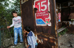 Boys rest under a poster for Bulgaria's Socialist party on a rusty bus stop on October 17th, 2014, in Rabrovo - the only village with a hospital near Kanitz, a nearly abandoned village of 6. Bulgaria has the most extreme population decline in the world — much due to post-1989 emigration, high death rates and low birth rates. There are so few people of child-bearing age in the nation that population statistics project a 30-percent decrease by 2060, from 7.2 million to just over 5 million. In other words, Bulgaria’s population declines by 164 people a day, or 60,000 people a year — 60 percent of them aged over 65.