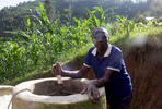 Etiene Twagirayezu, 60, talks about his biogas digester in front of his home in Rutabo, Rwanda, on November 18, 2017. Twagirayezu says that before his digester, he'd spend up to 3 hours a day gathering 10 kilograms of wood, and saw kids get injured climbing trees and be late to school doing the same. He added he was happy his workload at home was reduced due to being able to use his cow's and pig's poo instead of wood as fuel, as well as about the resulting lessening of deforestation. Nearly half of all Rwandans live in poverty, relying on small-scale farming for survival without gas or electricity. With so many women and children spending hours of the day foraging for wood used for cooking and light, often damaging their eyes, lungs, the forests and atmosphere, a little inventiveness helps. Enter cow and enter pig -- not just as a source of food, but also the heat needed to cook it. Or more specifically, their poo -- the fuel fed to a biogas digester, a tank that converts organic waste into methane. 