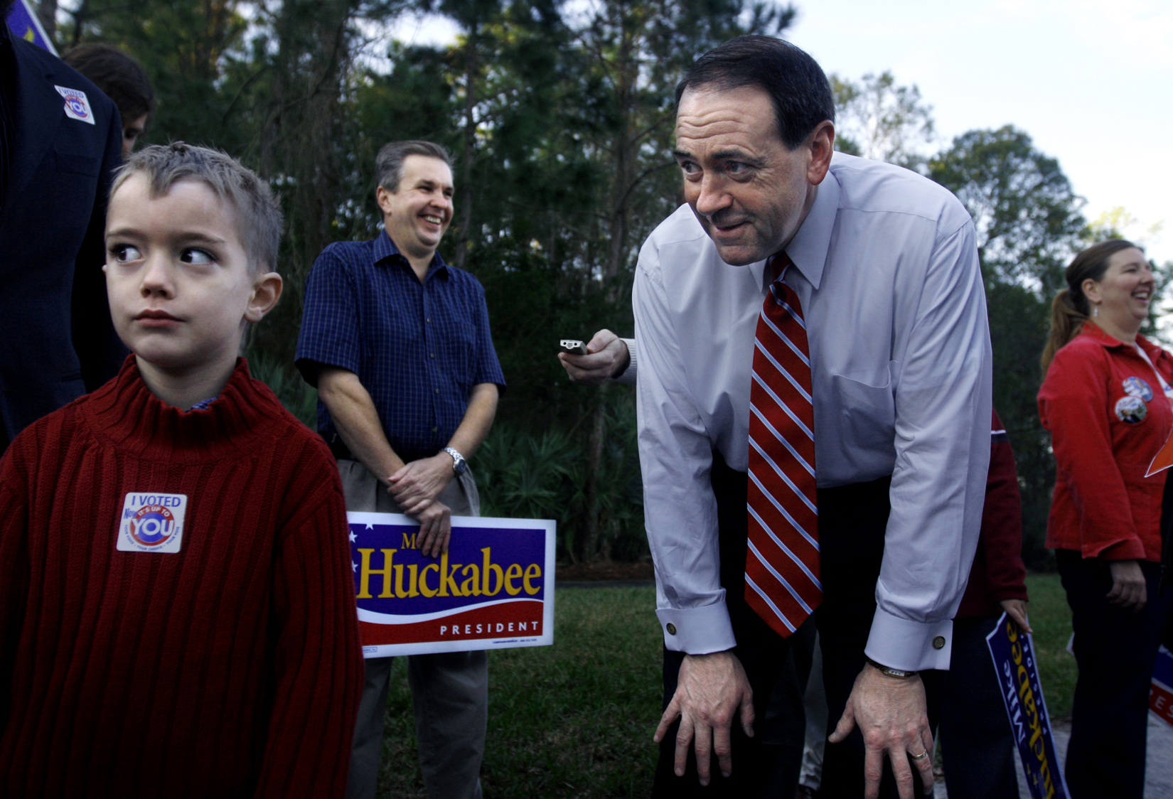 U.S. Presidential hopeful Mike Huckabee (R-AR) jokes around with five-year-old Luke Marks, from Tampa, Florida, by a polling site at the Westchase Swim and Tennis Center, where he stopped by to greet voters and potential supporters in Tampa, Florida, on the state's primary day, Tuesday, January 29, 2008.(For The New York Times)