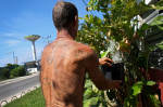 Jose Alonzo, sporting a USA tattoo, waters the plants in front of his house in the port city of Mariel, Cuba, a town whose tranquil appearance belies its important place in both the history and future of Cuban-American interaction. It is where Russians unloaded nuclear warheads in the 1962 Cuban missile crisis, and the gateway through which 125,000 Miami-bound emigres fled during the Mariel Boatlift of 1980. The town is now the site of construction of a deepwater container port and a free-trade zone, a critical ingredient for which will be the future of the U.S. embargo against Cuba, in place for more than 50 years but now under speculation of being lifted. 