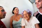 (L-R) Michael Denis Fonteto, his mother, Raizel Fonte Muñoz, grandmother Aida Muñoz, and brother, Yasiel Valdivia, spend time together in a village close to the port city of Mariel, Cuba. Yasiel and Michael's uncle was amongst those who fled toward Florida in the Mariel Boatlift exodus of 1980. The brothers say he has not since regained permission to return, separating him from his sister (their mother) and his 93-year-old mother, for 35 years. Mariel is a town whose tranquil appearance belies its important place in both the history and future of Cuban-American interaction. It is where Russians unloaded nuclear warheads in the 1962 Cuban missile crisis, and the gateway through which 125,000 Miami-bound emigres fled during the Mariel Boatlift of 1980. The town is now the site of construction of a deepwater container port and a free-trade zone, a critical ingredient for which will be the future of the U.S. embargo against Cuba, in place for more than 50 years but now under speculation of being lifted. 