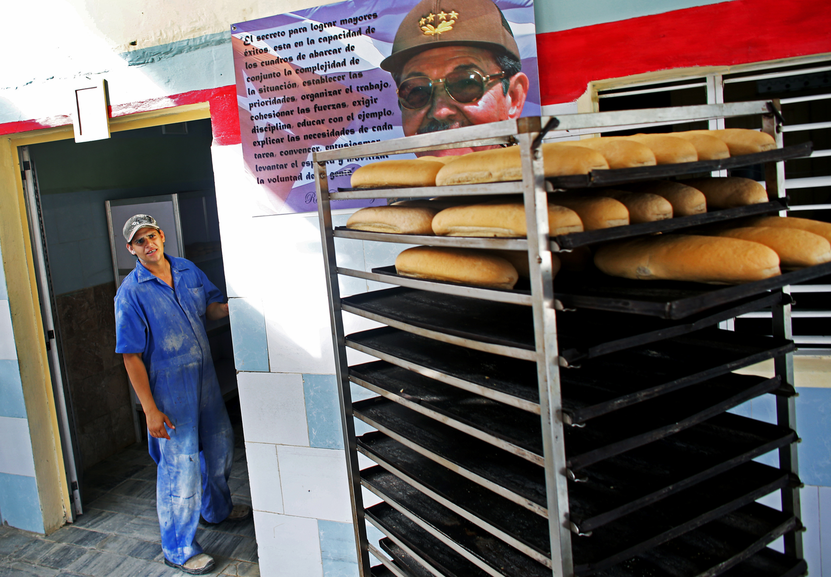 A bakery features a portrait of current president of Cuba Raúl Castro in the port city of Mariel, Cuba, a town whose tranquil appearance belies its important place in both the history and future of Cuban-American interaction. It is where Russians unloaded nuclear warheads in the 1962 Cuban missile crisis, and the gateway through which 125,000 Miami-bound emigres fled during the Mariel Boatlift of 1980. The town is now the site of construction of a deepwater container port and a free-trade zone, a critical ingredient for which will be the future of the U.S. embargo against Cuba, in place for more than 50 years but now under speculation of being lifted. 