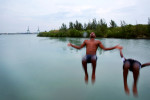 (L-R) Yandi Corrioso Samoraz, 22, and Raymel Medina, 16, go for an evening dip in the water, with construction of the new port visible in the background, in Mariel, Cuba. Raymel says he'd like to learn more about the world, but extremely limited internet access in his city, and in the country in general, makes this a challenge. (Internet access is either difficult to find, or prohibitively expensive.) Mariel's tranquil appearance belies its important place in both the history and future of Cuban-American interaction. It is where Russians unloaded nuclear warheads in the 1962 Cuban missile crisis, and the gateway through which 125,000 Miami-bound emigres fled during the Mariel Boatlift of 1980. The town is now the site of construction of a deepwater container port and a free-trade zone, a critical ingredient for which will be the future of the U.S. embargo against Cuba, in place for more than 50 years but now under speculation of being lifted. 