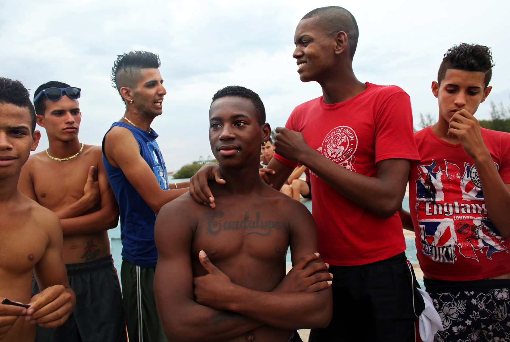 Raymel Medina, 16, (center,) relaxes with friends after an evening dip in the water in the port city of Mariel, Cuba. He says he'd like to learn more about the world, but extremely limited internet access in his city, and in the country in general, makes this a challenge. Internet in Cuba is either difficult to find, or prohibitively expensive. Travel outside of the island is also forbidden to most, except to those whose jobs allows it, or have a government connection.