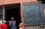 A list of available products hangs outside of a bodega (convenience store) in Havana, Cuba. Bodegas provide food rations - basics like rice, flour, sugar and beans, that exclude green veggies, most meat, spices or dairy (which is restricted to all but children and pregnant women) - to each Cuban citizen via the Libreta de Abastecimiento (supplies booklet,) which establishes the kind, amount and frequency of food allotted per person. The rations, which supply approximately 1/3 of Cubans' food requirements, have been kept at stable, subsidized prices since the program's inception in 1962 - as food can otherwise be forbiddingly expensive, and even at bodegas, hard to come by. This is due to a combination of inefficient farming policies, the U.S. embargo (in place since the 60s,) and the collapse of the Soviet Union in the 90s (which until then had filled the U.S.-Cuba trade vacuum with subsidies.) Food shortages, while common today, were especially sharp then, both in Bulgaria and Cuba, as the two countries tried to adjust to a non-Soviet-sponsored economy. 