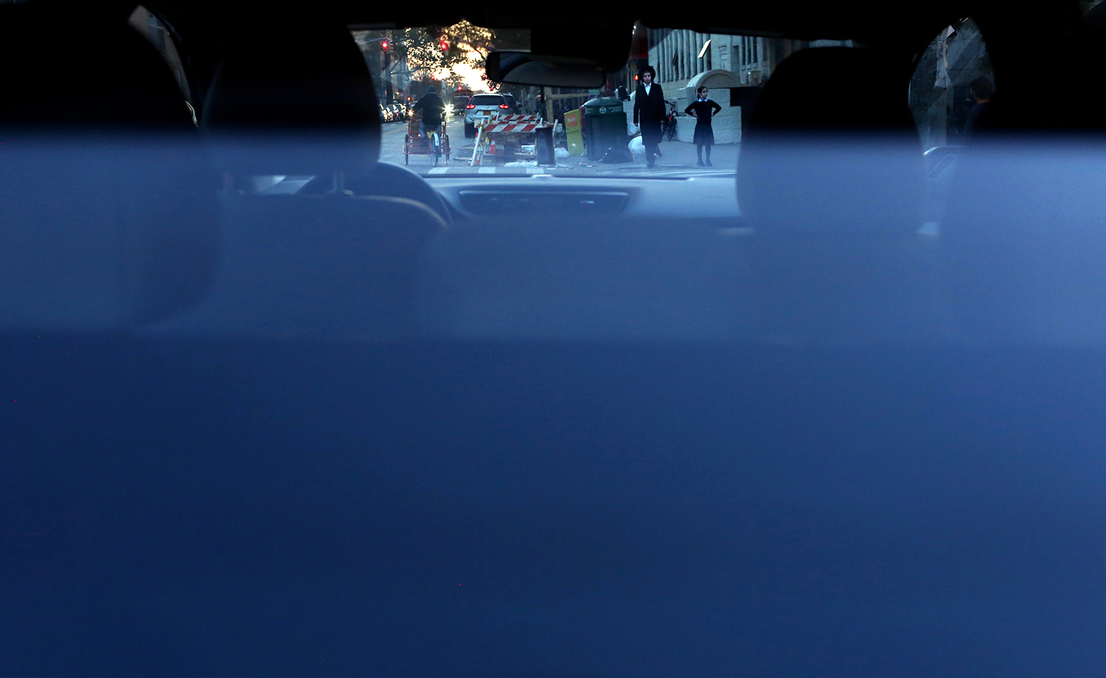 A boy and a girl are seen through a car's rear windshield in Borough Park in Brooklyn, New York on November 05, 2020. (Photo by: Yana Paskova for The New York Times/the National Geographic Society)