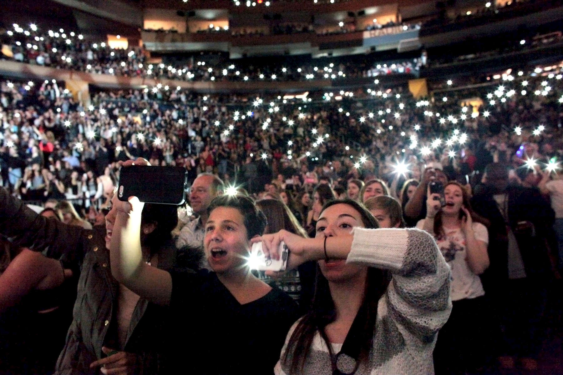An audience lights up their cell phones instead of lighters, as Sam Smith performs during Jingle Ball at Madison Square Garden in Manhattan, New York on December 12, 2014. The crowd, much like the holiday performance, was energized and sparkling, festive under the glow of reindeer horns, glitter and of course, their cell phones. (For Rolling Stone)