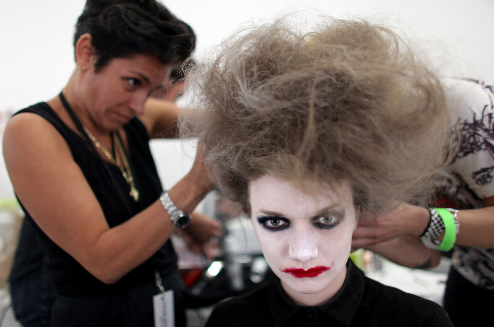 A model gets her hair and make-up done before the Thom Browne show at Mercedes-Benz Fashion Week in Manhattan, New York, on September 09, 2013. (For The New York Times)