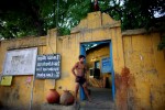 An Indian man who practices traditional Kushti wrestling takes a break by the entrance of the wrestling yard on Monday, June 01, 2009 in New Delhi, India. 