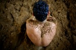 Rohit Chiller, an Indian man who practices traditional Kushti wrestling, rubs dirt all over himself before starting practice on Monday, June 01, 2009 in New Delhi, India. 