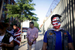 (L-R) Tenzin Dolkar, Tenzin Norsang, Hussein Khalique, and Tenzin Norgay walk around DUMBO during halftime of a screening of the US-Portugal World Cup game under the Manhattan Bridge archway in Brooklyn on June 22, 2014. The game ended 2-2 in overtime. (For The New York Times)