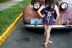 Felicita Pomares, 9, checks out a 1938 Plymouth Road King vintage car, on the way to the Fourth of July Parade in Montclair, NJ, on July 04, 2017.(For The New York Times)