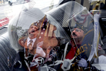 Veterans' reflections are seen on the car window of Eve Stollak, wife of army veteran Jack Stollack, as they prepare to participate in the The Little Neck-Douglaston Memorial Day Parade, the largest in the nation, in Little Neck, NY on May 29, 2017.(For The New York Times)