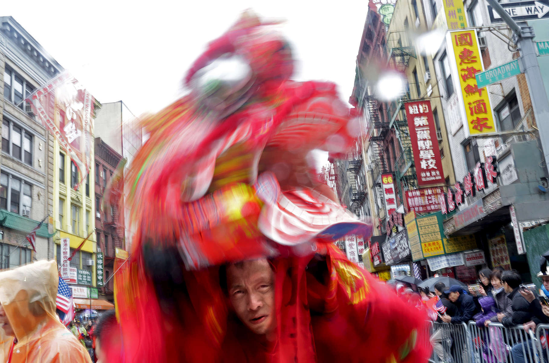 A participant in the Chinatown Lunar New Year Parade fiddles with his mask in Manhattan, NY on February 25, 2018.