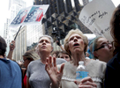 (L-R) Hillary Ewing and her aunt, Sally Weiner, join thousands of people in front of Trump Tower in Manhattan, NY, on August 14, 2017, protesting this weekend's violent white nationalist rallies in Charlottesville, Virginia.-“Trump Gawkers{quote} is a visceral look at what draws people to Trump Tower, the current residence of U.S. President elect Donald Trump. Hoards of people undertake the trek, bearing security and weather roadblocks, to stare, gawk, absorb, record. The magnetism to the tower (and by extension, to the man inside it,) manifests in the sheer numbers of daily visitors, as well as in the fascination etched across their faces. Upon first look, the time so many spend there seems like sport and amusement, but underneath upturned eyes and selfie smiles prevails an undercurrent of anxiety - and not just for those who didn't want Trump in the Oval Office. Some of the electorate that voted against Hillary is now unsure for which version of Trump they voted. People's upward gazes, no matter their political views, seek answers: How could this happen? Or now that it has, what will it mean? 