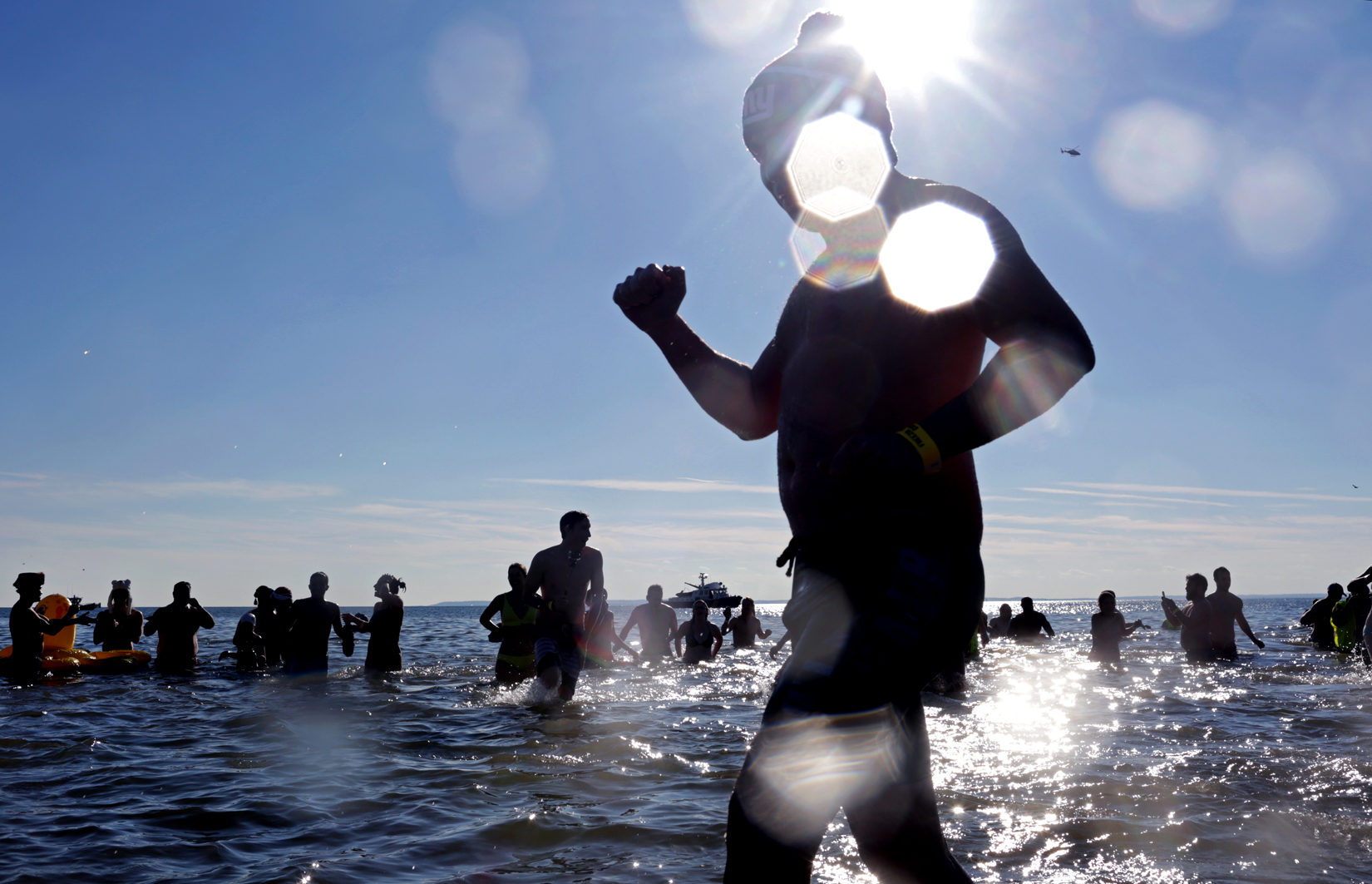 Swimmers run into the ocean during Coney Island Polar Bear Club's New Year's Day Plunge in Brooklyn, NY on January 01, 2017. (For Getty Images)