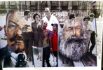 My grandfather (center,) seen walking with Romanian and Bulgarian colleagues in Bulgaria in the 1970s as part of a mandatory work function. The banner in the background reads “Glory to the USSR.” And in Cuba, participants in the First of May Labor Day parade hold posters of Russian Communist leader Vladimir Lenin and German Communist revolutionary Karl Marx. This day, simply labeled Día del Trabajo (Labor Day,) is a call for people of all nations to show support for socialist reform — and in Cuba, for the Cuban Revolution. But in Cuba, as in pre-1989 Bulgaria, while attendance is not mandatory, absences from these marches are frequently noted, discouraged, and often followed with punitive measures (social and professional.) Fraying family pictures from pre-1989 Bulgaria inspired this portion of a long-term project on Democracy + Communism. The parallels between them and photos I'd taken in present-day Cuba surface best when juxtaposed — one image layered on top of the other. And so, I attempt to bridge one country’s past to another country’s present — to show that political ideals, its profiteers and its victims, can remain unchanged by time or geography. 