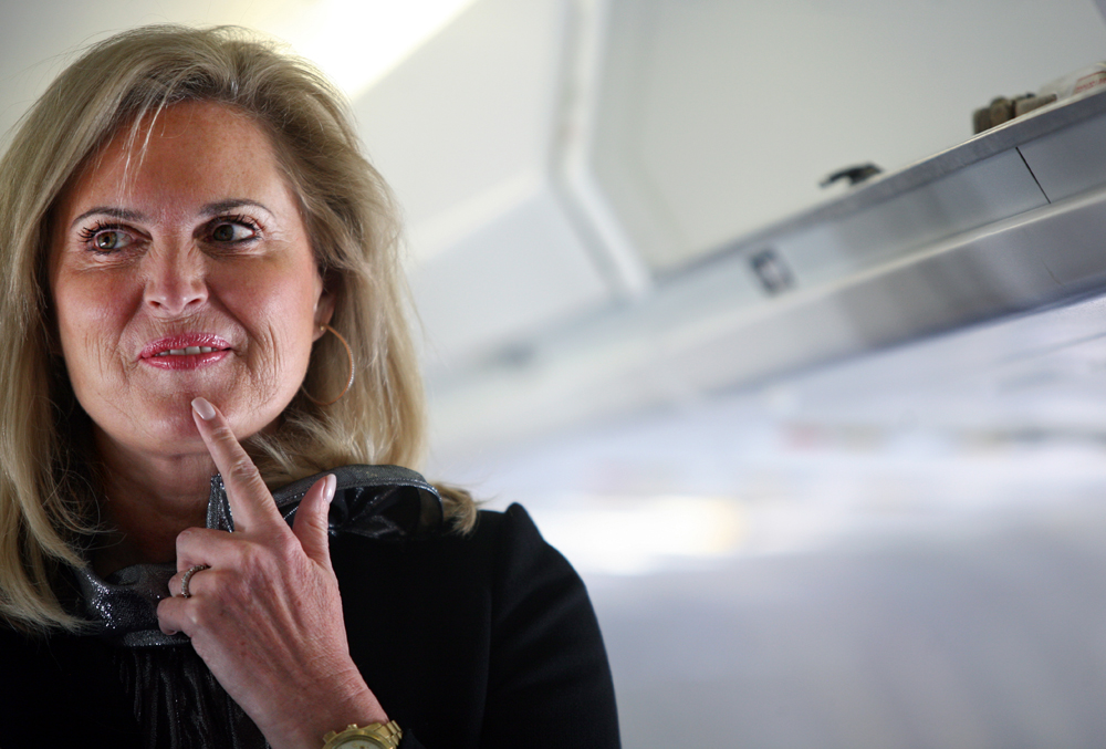 Ann Romney, wife of Republican Presidential candidate Mitt Romney (R-MA), listens to him speak with reporters on their plane before it takes off from Columbus International Airport in Columbus, Ohio on Tuesday, March 06, 2012. (For The New York Times)
