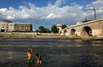 (L-R) Two Macedonian gypsy boys, Elis and Martin, swim in the river Vardar near the Stone Bridge in Skopje, Macedonia on Sunday, September 05, 2010.  (For The New York Times)(For The New York Times)(For The New York Times)