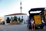 A boy plays with strings holding crates inside a car near the Murat Pasha mosque in the Old City portion of Skopje, Macedonia on Sunday, September 05, 2010.  