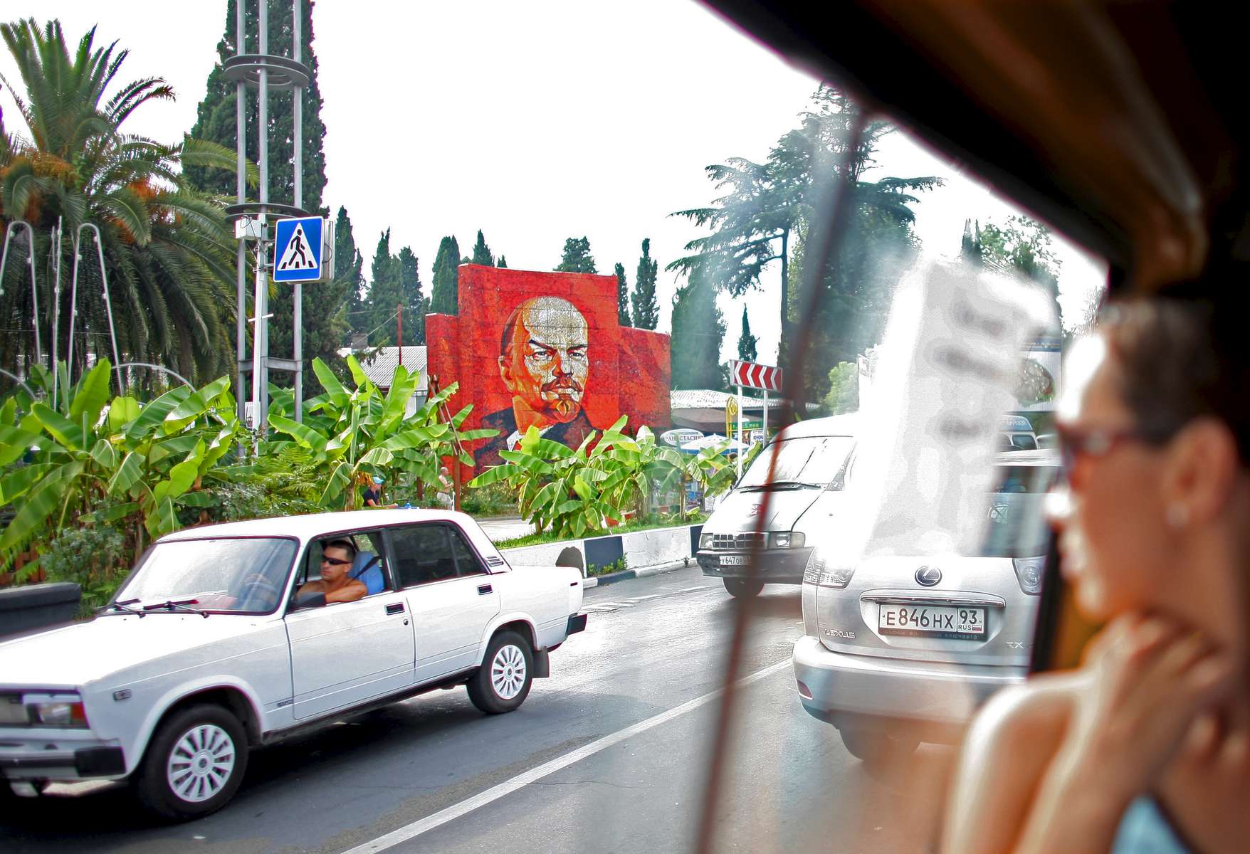 Investors have flooded the Russian beach town of Sochi since its award as the 2014 Winter Olympics location in an effort to create a Mediterranean-style resort. Here, a bus rider glances at a mural of the Russian communist politician Vladimir Lenin on Tuesday, August 12, 2008. As the mountainous Black Sea resort Sochi, Russia, prepares for the Winter Olympic games scheduled there for 2014, it emerges as a place replete with contradictions -- glitzy clubs and impoverished street vendors, progress and repression, Westernization and former Eastern bloc ideologies.(For The New York Times)