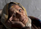 Meena Devi, 78, a widow, falls deep in thought at Rak Kuti ashram in Varanasi, India on January 07, 2019. Meena is originally from Nepal, and has lived in the ashram for the past 25 years. Before that, she lived in the same building as Sita Devi, 52, and her mother-in-law, Goma Devi, 96, who now also occupy this ashram. Meena is a child widow. {quote}Maybe I was cursed and I would have been forbidden to attend any functions because my husband died at a young age,{quote} she says. So with the help of relatives she moved here to live among other widows. She didn't want to marry again after her husband's death.