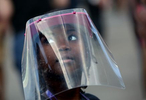 A young girl under a face shield (who wanted to be photographed, with her mother's permission,) watches hundreds of people gather to protest police violence at Grand Army Plaza in Brooklyn, New York, on June 07, 2020. Peaceful demonstrations, which elicited teargassing, rubber bullets and mass arrests by police, spread throughout the country and the world in response to the death of George Floyd, an African-American man who Minneapolis police killed via extensive neck and back compression during an arrest at the end of May. Photo by: Yana Paskova © 2020