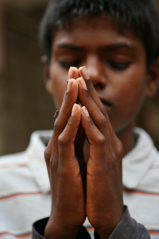 Thirteen-year-old John Peter says his evening prayer before eating dinner. {quote}We do not convert here. We have Christians, Hindus and Muslims,{quote} said John Kennedy Samson, Morning Star’s director.